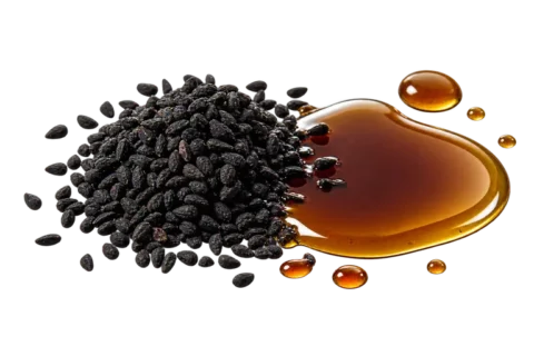Black cumin seeds beside black seed oil